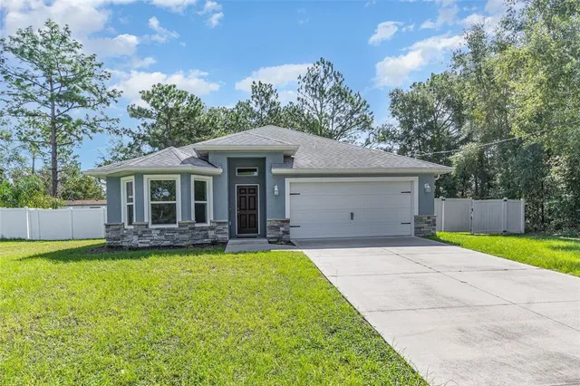 a front view of a house with a yard and porch