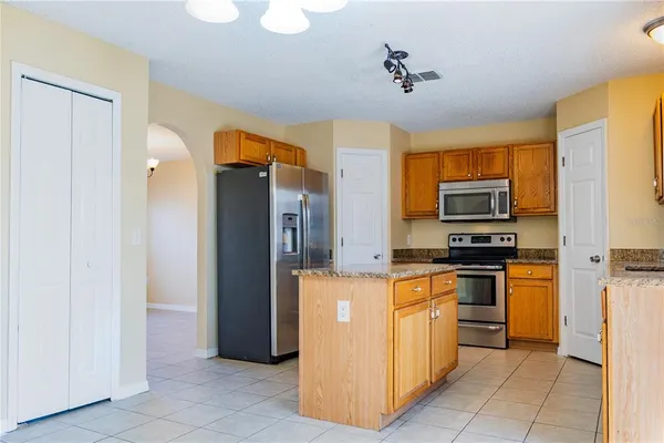 a kitchen with stainless steel appliances a refrigerator and a stove top oven