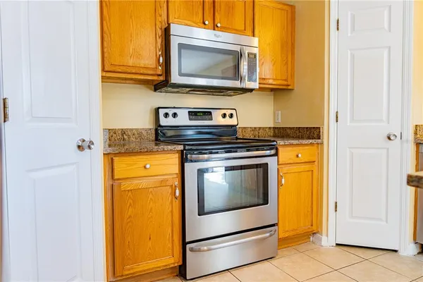 a kitchen with a stove microwave and sink