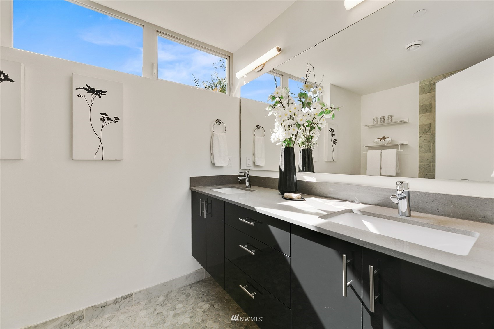 327 West Olympic Place, Unit F Seattle, WA 98119 - Photo 15 of 39 a bathroom with a granite countertop sink a large mirror and a shower