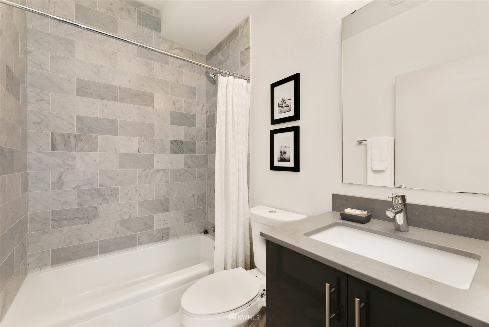 327 West Olympic Place, Unit F Seattle, WA 98119 - Photo 22 of 39 a bathroom with a granite countertop sink toilet and shower
