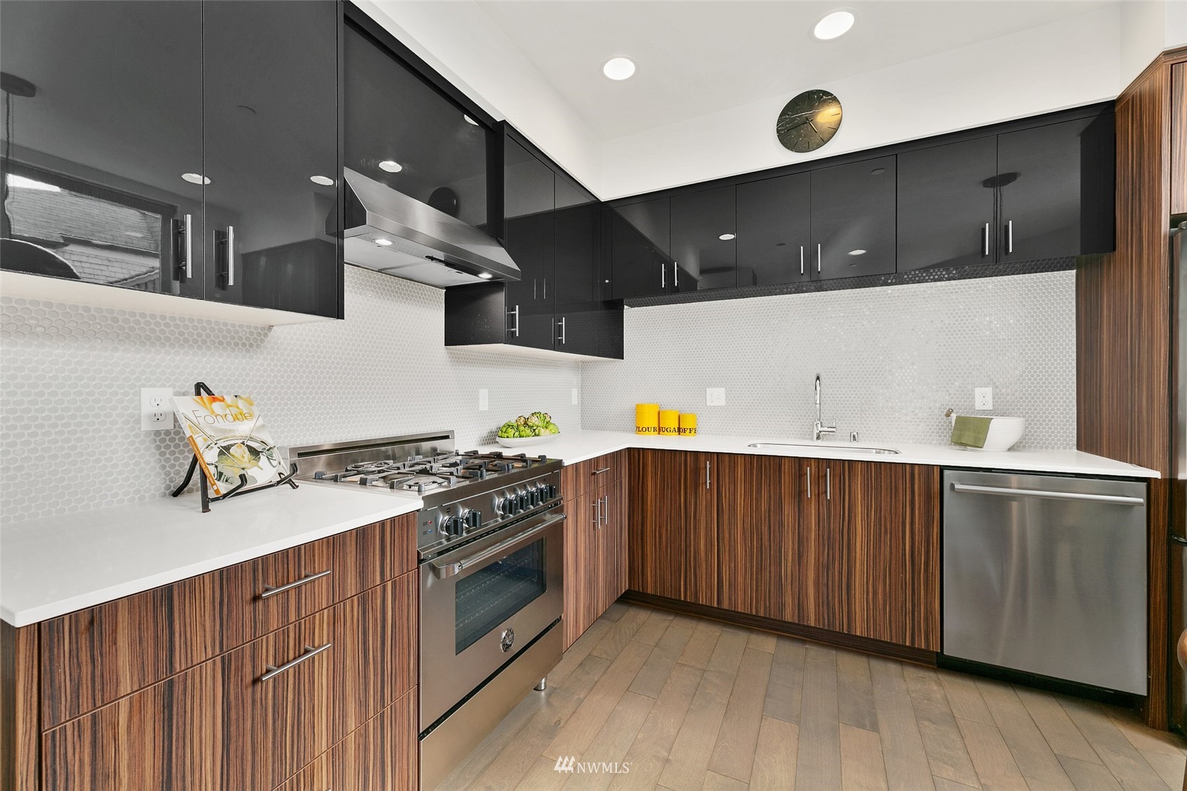 327 West Olympic Place, Unit F Seattle, WA 98119 - Photo 6 of 39 a kitchen with stainless steel appliances a stove a sink and a refrigerator