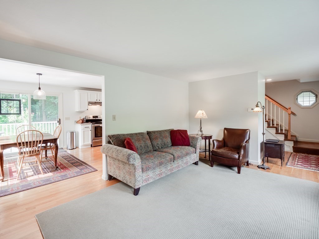 4 Crabtree Lane Shirley, MA 01464 - Photo 16 of 36 a living room with furniture and a dining table with kitchen view