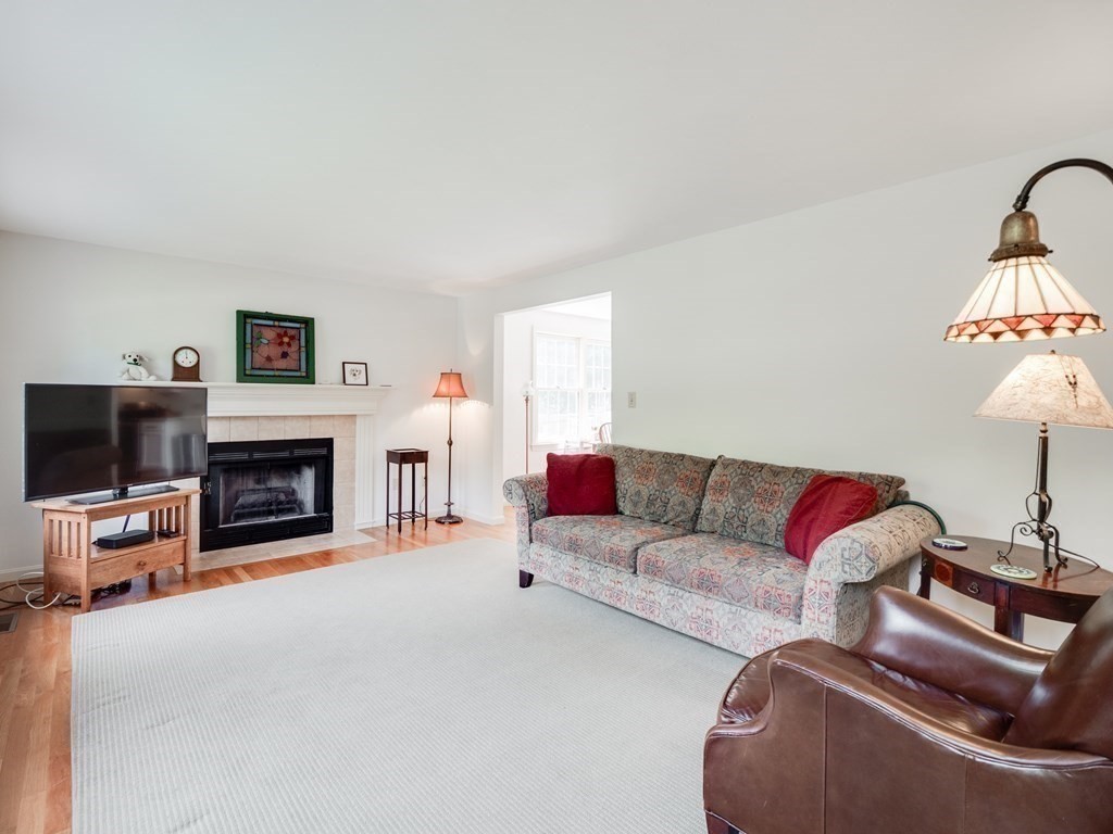 4 Crabtree Lane Shirley, MA 01464 - Photo 17 of 36 a living room with furniture a fireplace and a flat screen tv