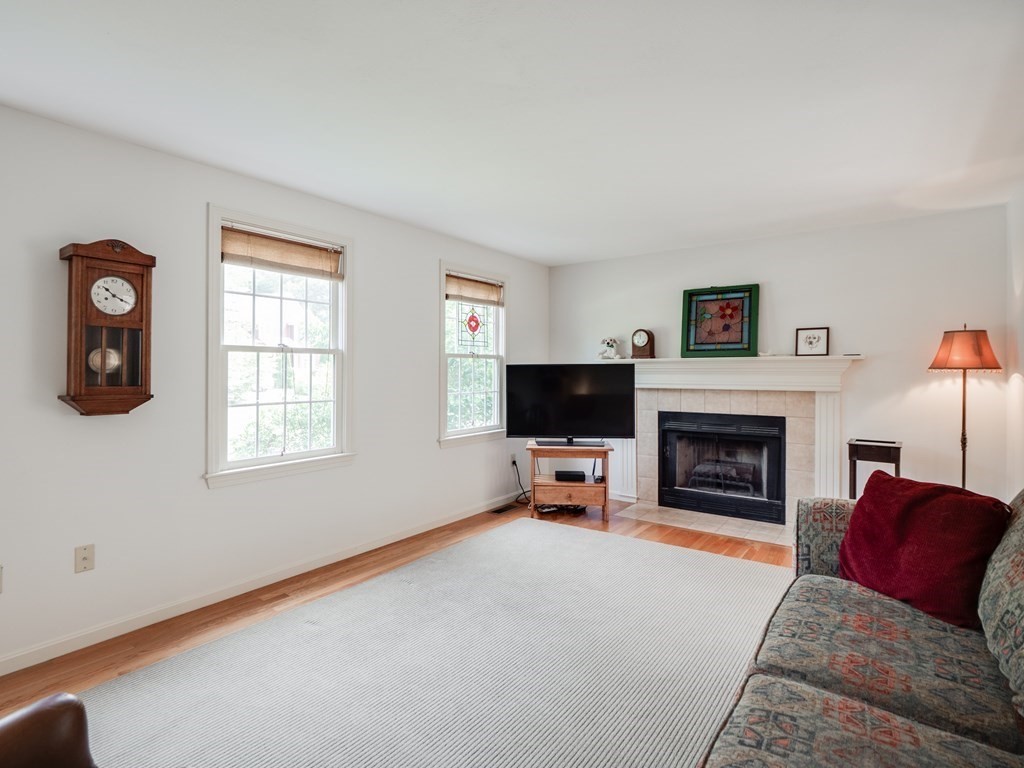 4 Crabtree Lane Shirley, MA 01464 - Photo 18 of 36 a living room with furniture a flat screen tv and a fireplace