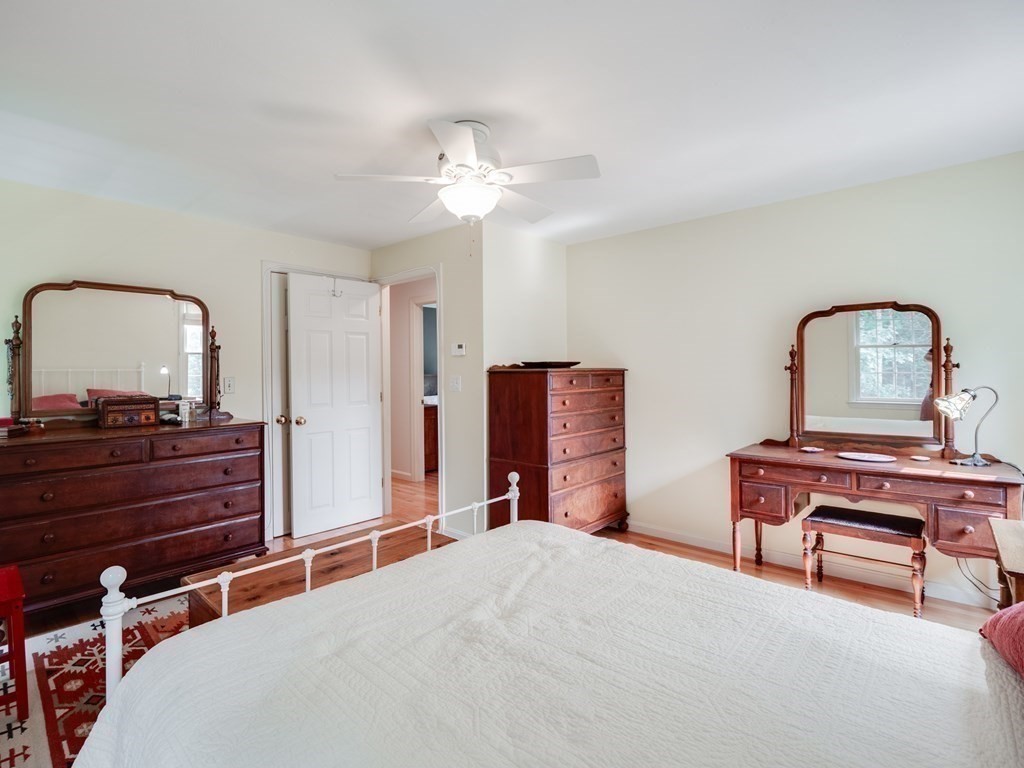4 Crabtree Lane Shirley, MA 01464 - Photo 24 of 36 a bedroom with a bed and a dresser with potted plants