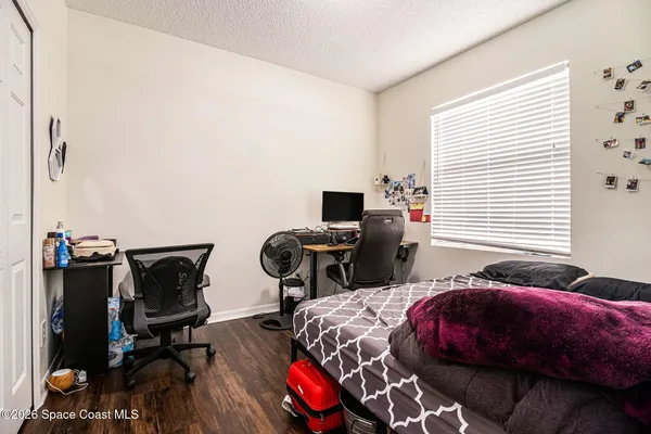 a bedroom with two bed and a window