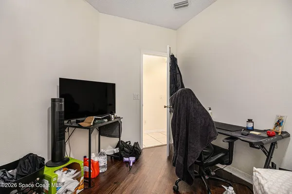 a view of workspace with wooden floor windows