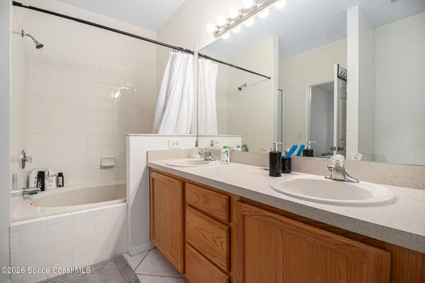a bathroom with a tub sink and mirror