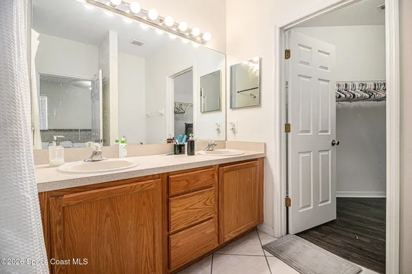 a bathroom with a double vanity sink and mirror