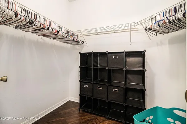 a view of walk in closet with clothes