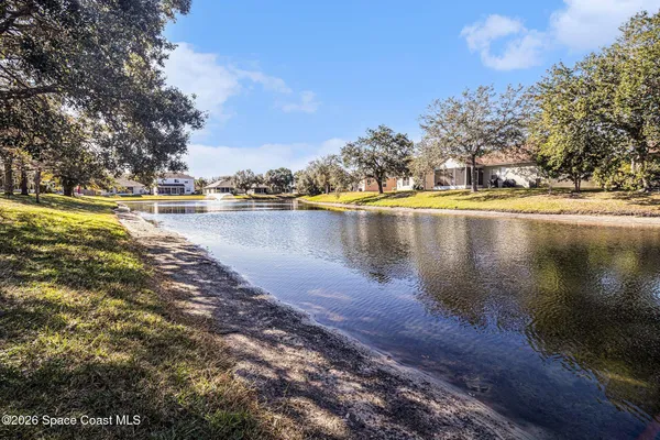 a view of a lake with houses in the back