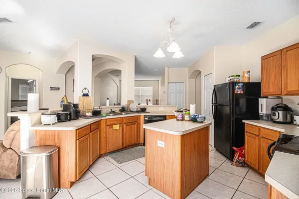 a kitchen with a sink refrigerator and cabinets