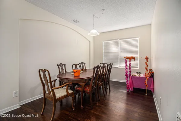 a view of a dining room with furniture and wooden floor