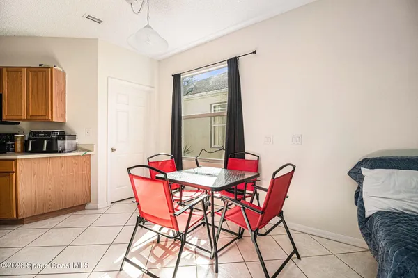 a dining room with furniture and window
