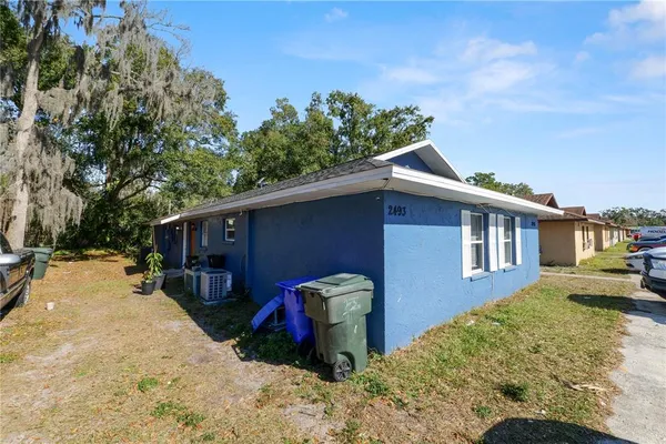 a backyard of a house with a tree