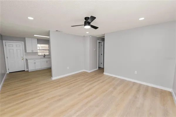 a kitchen with white cabinets stainless steel appliances and sink