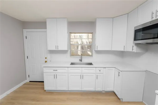 a kitchen with a refrigerator sink and microwave
