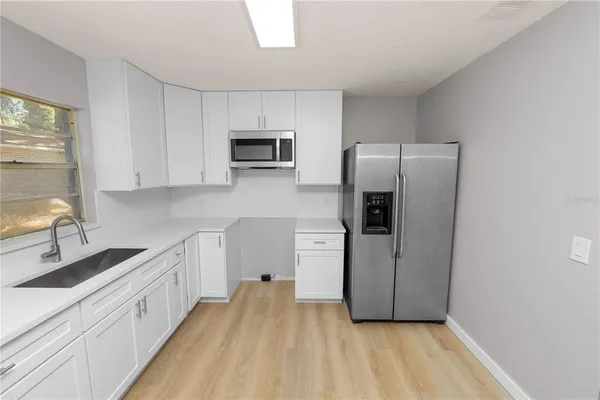 a view of a kitchen with electric appliances
