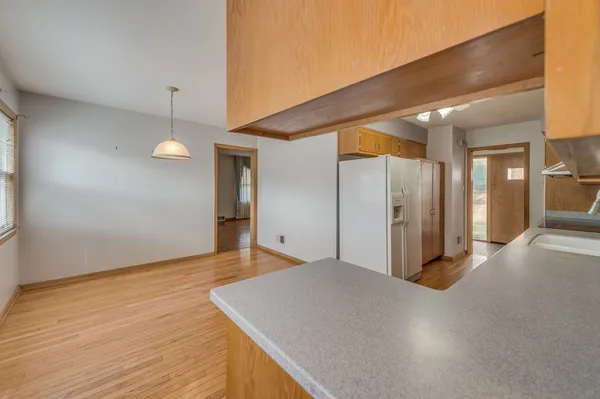 a view of a hallway with wooden floor