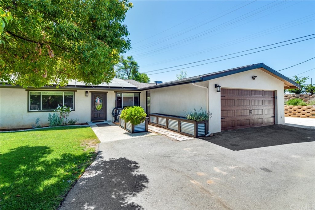 a view of a house with a yard and garage