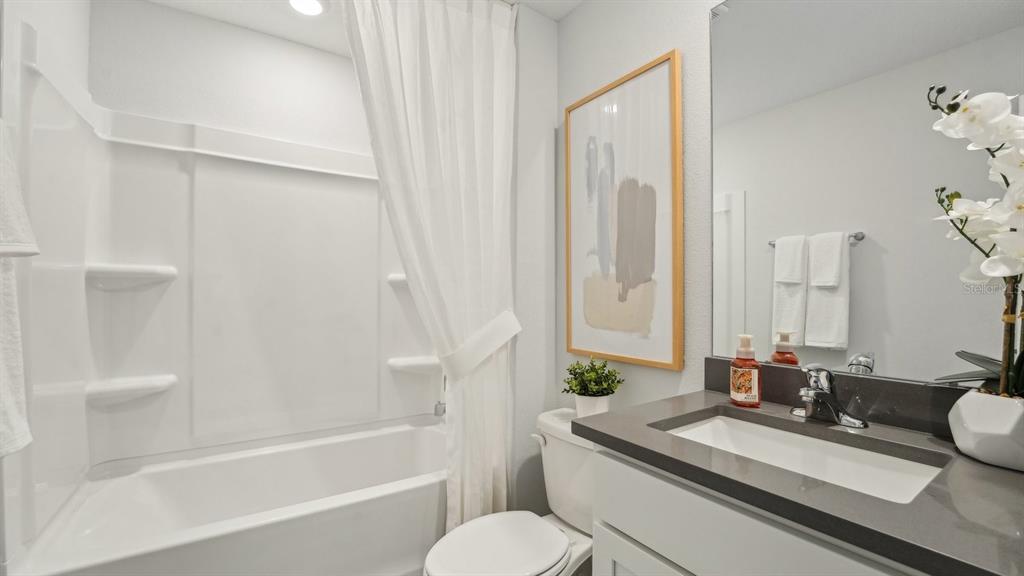 9806 Southeast 161st Lane Road Summerfield, FL 34491 - Photo 21 of 29 a bathroom with a granite countertop sink toilet and shower