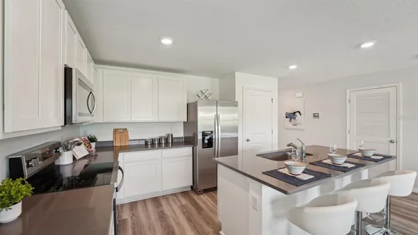 a kitchen with a sink stove and refrigerator
