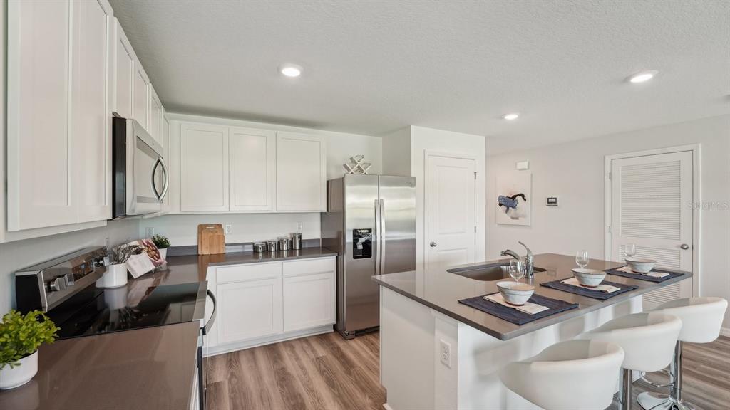 9806 Southeast 161st Lane Road Summerfield, FL 34491 - Photo 5 of 29 a kitchen with a sink stove and refrigerator