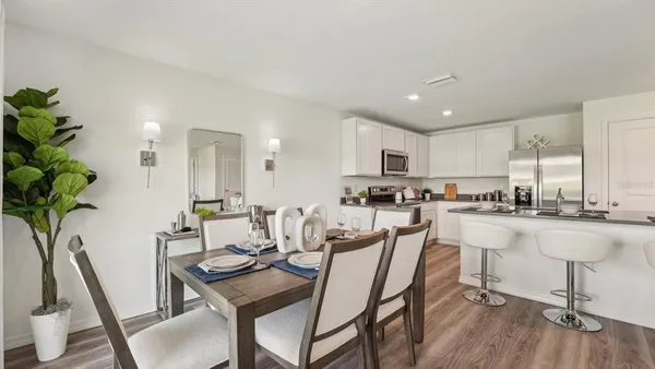a view of a dining room with furniture window and wooden floor
