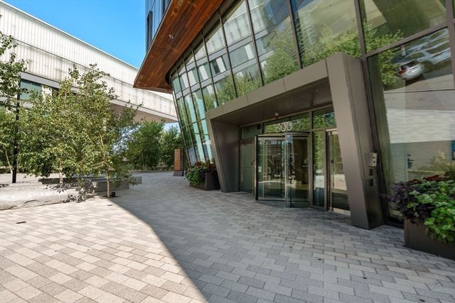 a wooden bench sitting in front of a building