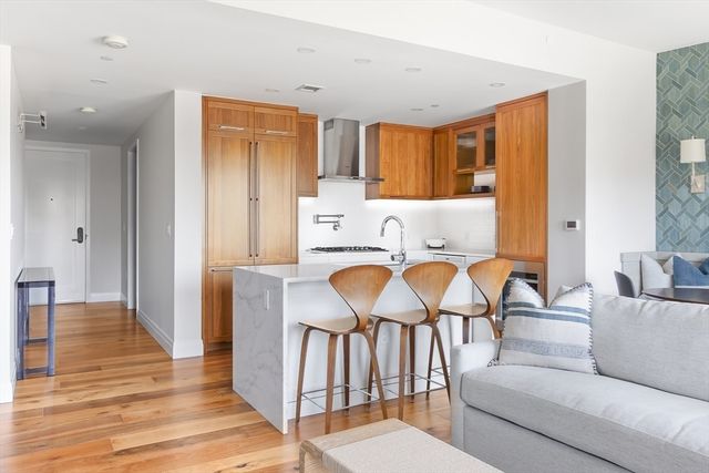 a living room with furniture a dining table and chairs with wooden floor