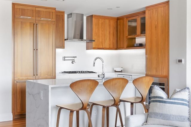a bathroom with a tub a sink and a window