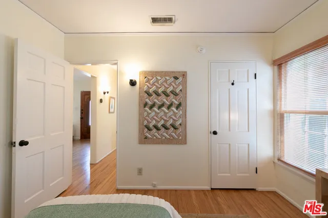 a view of a room with wooden floor and cabinet