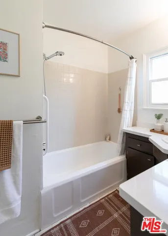 a bedroom with bed and a night stand