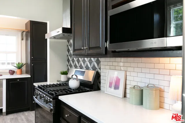 a kitchen with stainless steel appliances granite countertop a stove and a sink