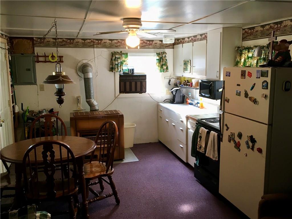 662 Bean Farm Road Sheffield, PA 16347 - Photo 7 of 21 Window AC, Table and chairs, Microwave, Stove and Refrigerator are all included in the sale of the property