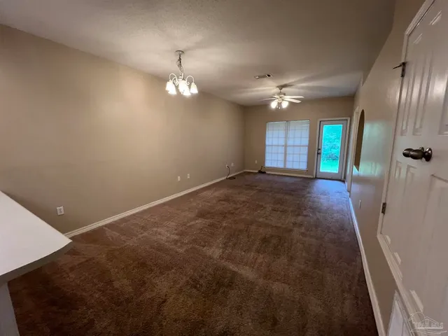 a large kitchen with stainless steel appliances a large counter top a stove and a refrigerator