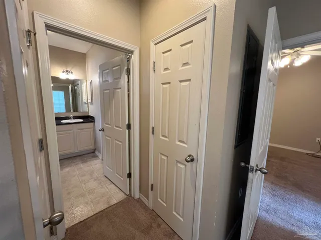 a bathroom with a granite countertop toilet sink and mirror