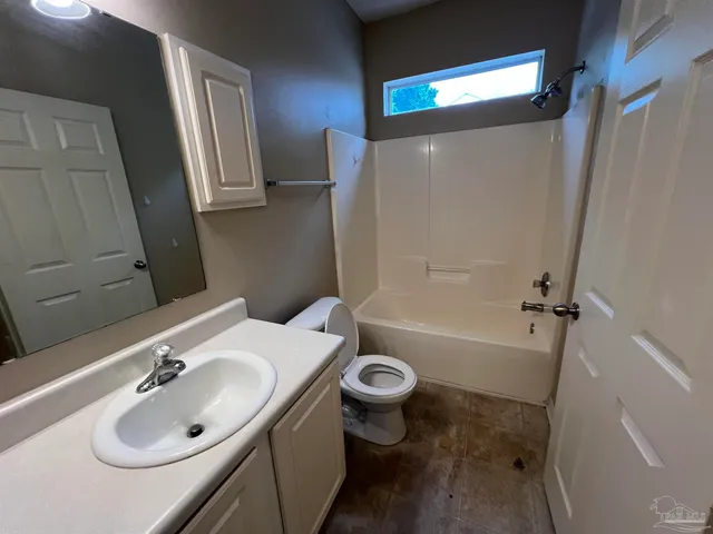 a bathroom with a sink a toilet a mirror and vanity