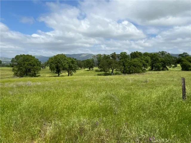 a view of a green field with house