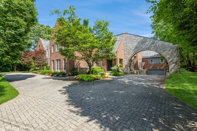 a front view of a house with a yard and a garage