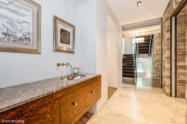 a spacious bathroom with a granite countertop sink and a mirror