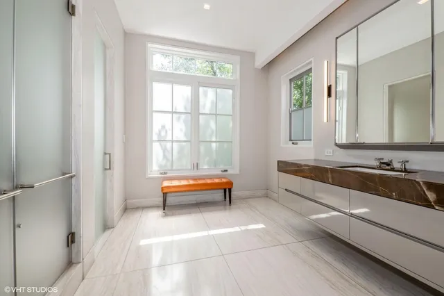 a bathroom with a tub sink and mirror