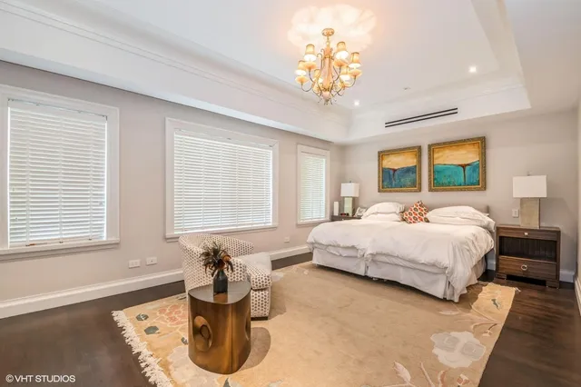 a bed room with a bed and a chandelier