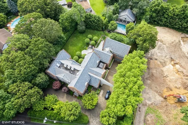 an aerial view of a house with a yard and garden