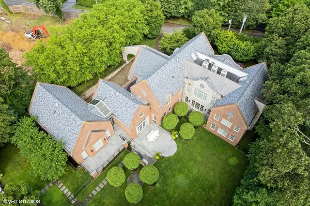 an aerial view of a house with garden space and street view