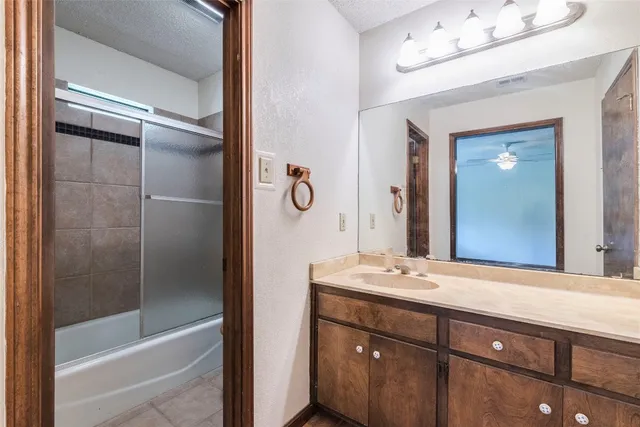a bathroom with a bathtub a sink and a mirror