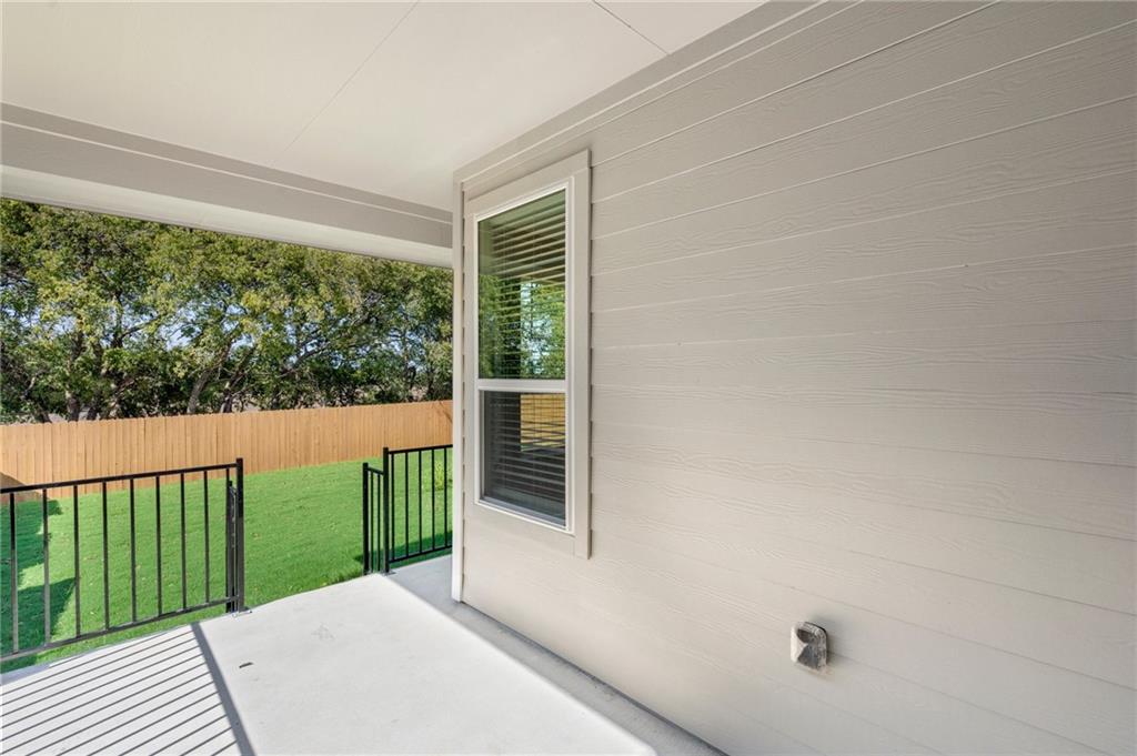 1012 Paddock Lane Georgetown, TX 78626 - Photo 10 of 15 A spacious covered patio overlooks a private, fenced backyard with mature trees.