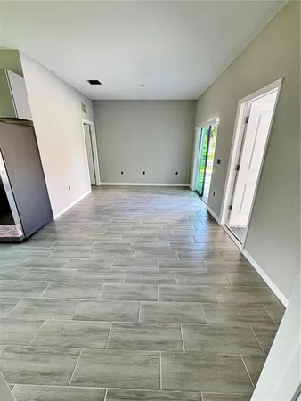 a view of a room with wooden floor and staircase
