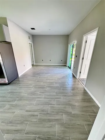 a view of a room with wooden floor and staircase